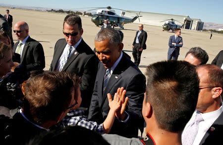 U.S. President Barack Obama gets a high-five from a child as he arrives at Moffett Federal Airfield in San Jose, California, U.S. June 23, 2016. REUTERS/Kevin Lamarque
