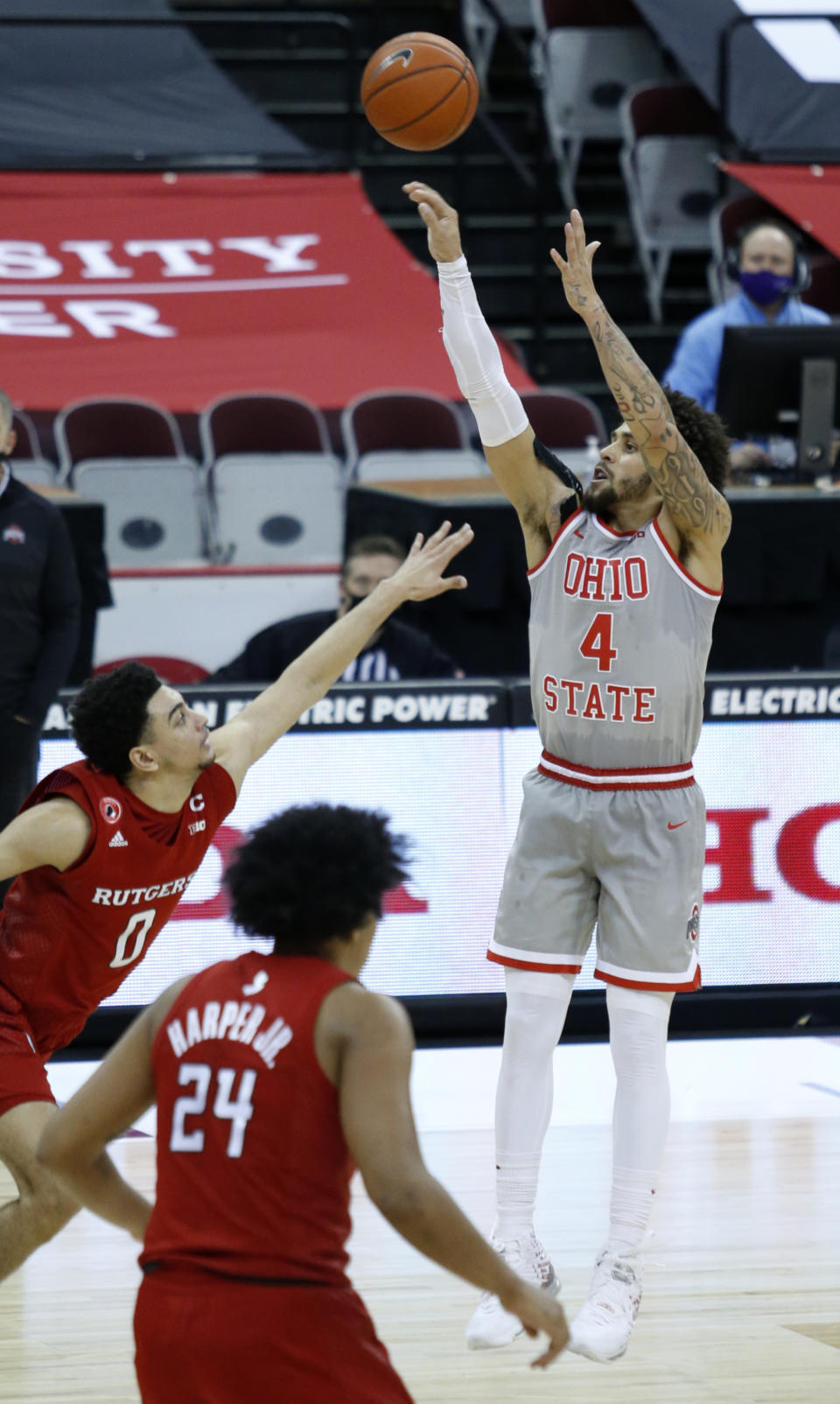 Ohio State guard Duane Washington shoots over Rutgers guard Geo Baker, left, and guard Ron Harper during the second half of an NCAA college basketball game in Columbus, Ohio, Wednesday, Dec. 23, 2020. (AP Photo/Paul Vernon)