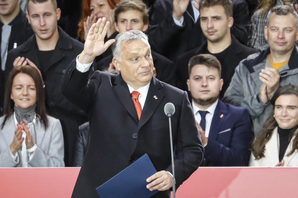 Hungarian Prime Minister Viktor Orban waves to supporters during celebration the 65th anniversary of the 1956 Hungarian revolution, in Budapest, Hungary, Saturday, Oct. 23, 2021. Thousands of supporters of Prime Minister Viktor Orban, who is expected to deliver a speech marking the 65th anniversary of the 1956 Hungarian revolution, march in Budapest, Hungary to demonstrate loyalty to his right-wing government. (AP Photo/Laszlo Balogh)