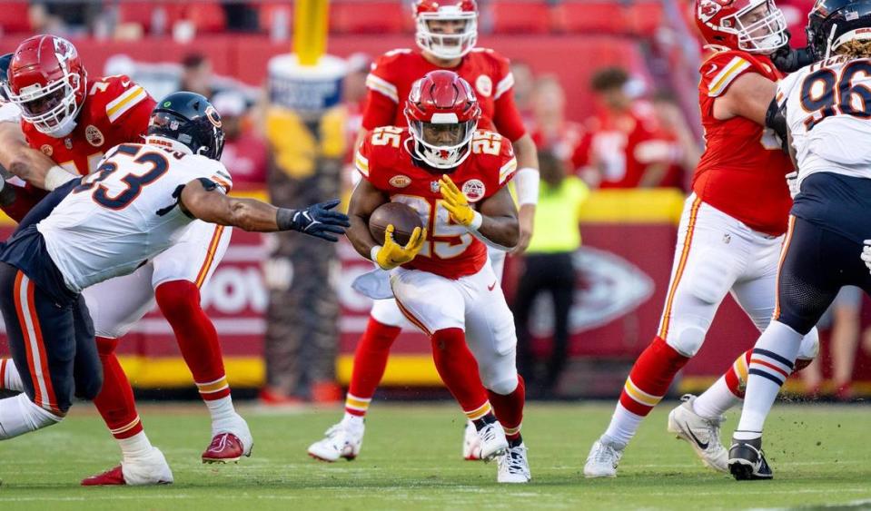 Kansas City Chiefs running back Clyde Edwards-Helaire (25) runs through a hole created by the offensive line against the Chicago Bears during an NFL football game at GEHA Field at Arrowhead Stadium on Sunday, Sept. 24, 2023, in Kansas City.