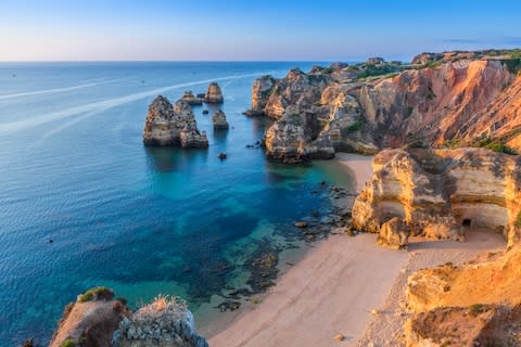 Spectacular limestone rocks dot the coast near Lagos - Credit: GETTY