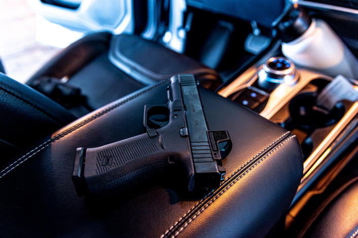 A 9mm handgun sits in a car Tuesday in Oklahoma City.