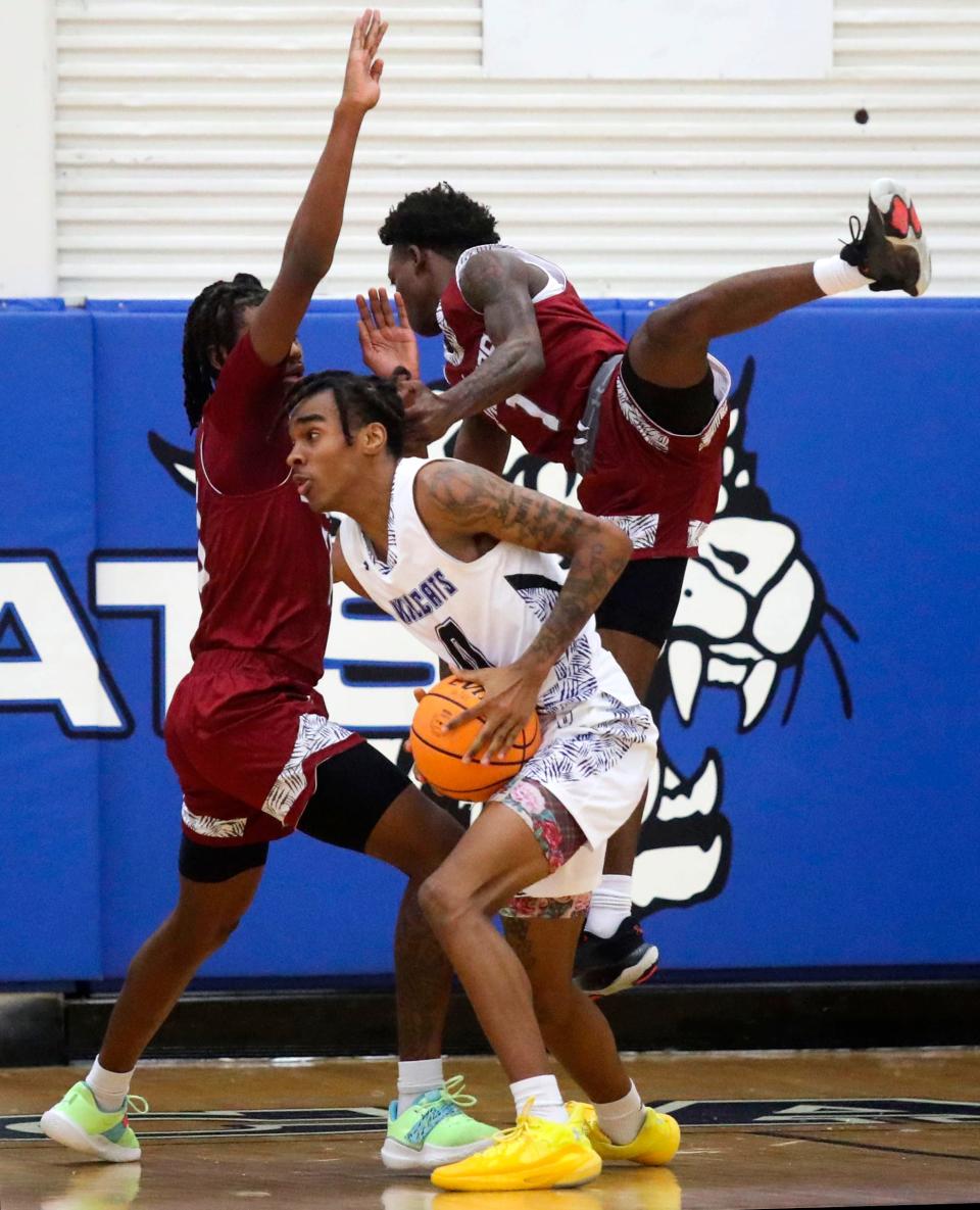 Howard's Xavier Richards-Powell works as Appoquinimink's Elijah Brooks (left) and Haji Bell converge on him in the first half of Howard's 53-47 win Tuesday, Jan. 10, 2023 at Howard High School. 