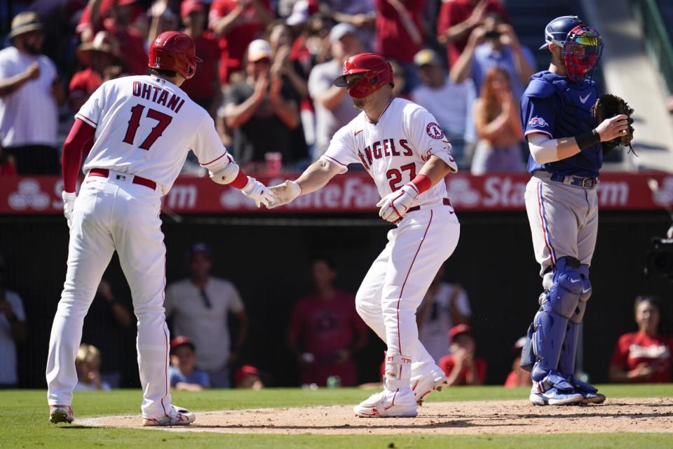 Angels' Mike Trout celebrates with designated hitter Shohei Ohtani after hitting a home run.