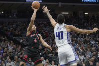 Toronto Raptors forward Scottie Barnes (4) shoots over Sacramento Kings forward Trey Lyles (41) during the first quarter of an NBA basketball game in Sacramento, Calif., Wednesday, Jan. 25, 2023. (AP Photo/Randall Benton)