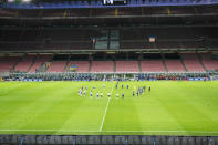 Players observe a minute of silence to honor the victims of coronavirus, prior to the start of the Serie A soccer match between Inter Milan and Sampdoria at the San Siro Stadium, in Milan, Italy, Sunday, June 21, 2020. (AP Photo/Antonio Calanni)