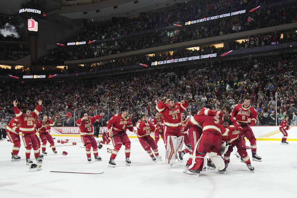 Denver celebrates after winning the championship game against Boston College in the Frozen Four NCAA college hockey tournament Saturday, April 13, 2024, in St. Paul, Minn. Denver won 2-0 to win the national championship. (AP Photo/Abbie Parr)