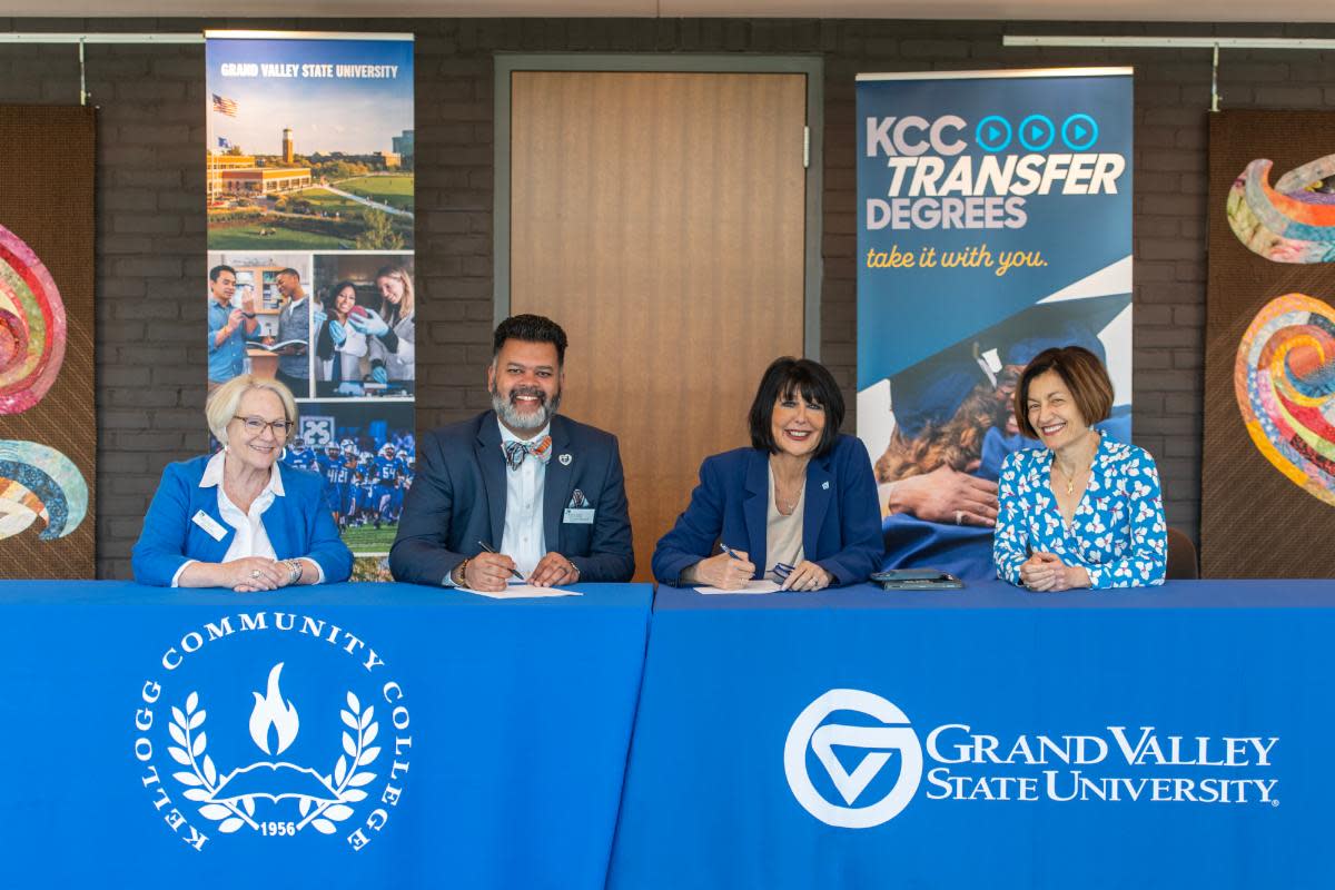 KCC Vice President for Instruction Tonya Forbes, KCC President Paul R. Watson II, GVSU President Philomena V. Mantella and GVSU Provost Fatma Mili sign an institutional articulation agreement during a public ceremony Friday inside the Binda Performing Arts Center.