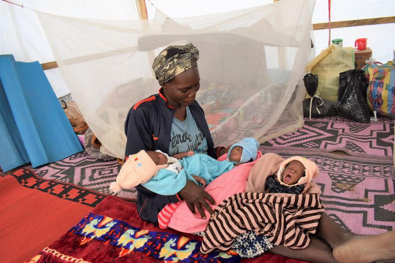 Fatime Eliane, a Cameroonian woman, holds her newly born triplets at the refugee camp on the outskirts of N'djamena