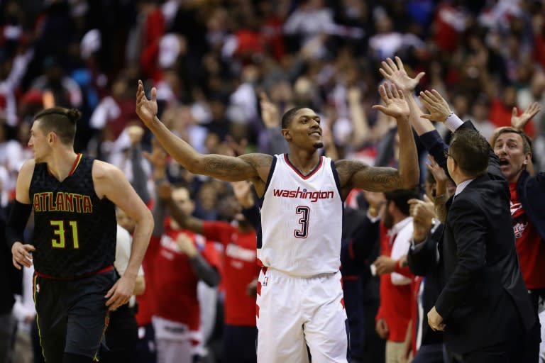 Bradley Beal of the Washington Wizards celebrates with head coach Scott Brooks in their 109-101 win over the Hawks in Game Two of the Eastern Conference Quarterfinals