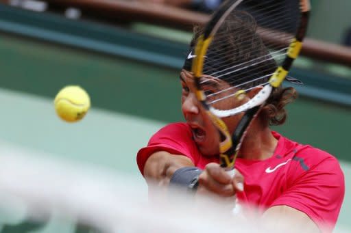 Spain's Rafael Nadal hits a return to Spain's David Ferrer during their semifinal tennis match of the French Open tennis tournament. Nadal won 6-2, 6-2, 6-1