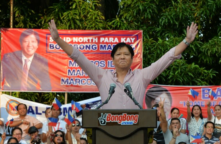 Ferdinand Marcos Jr., the son of late Philippine dictator Ferdinand Marcos, waves to supporters after delivering a speech announcing his vice-presidential bid, at a political rally in Manila on October 10, 2015