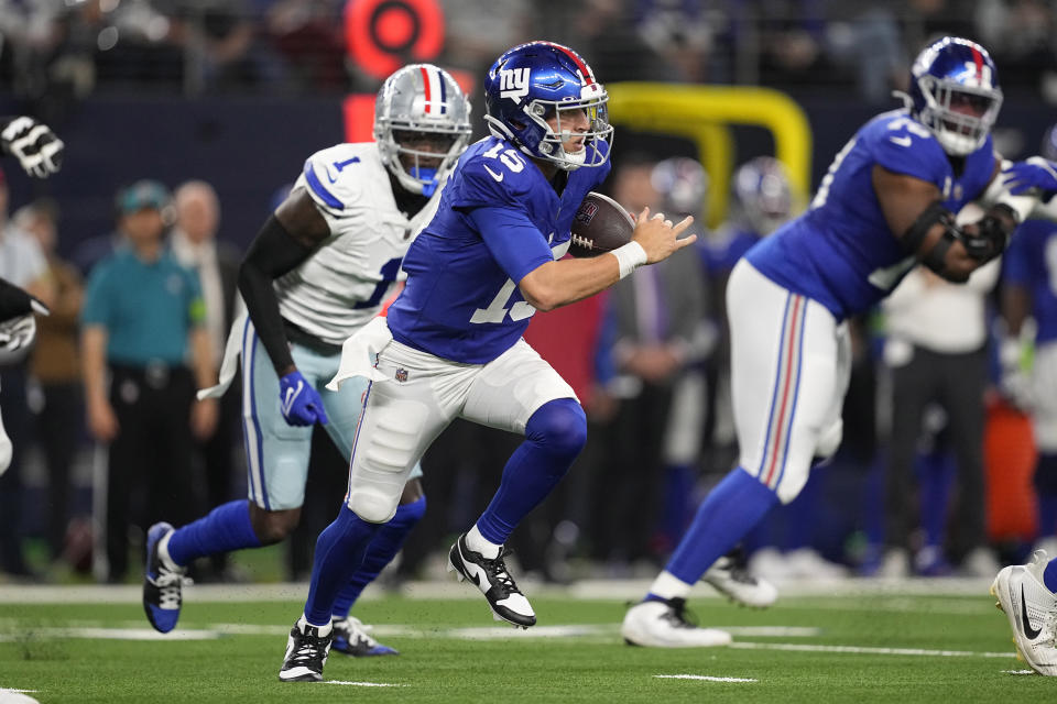 New York Giants quarterback Tommy DeVito (15) scrambles in the first half of an NFL football game against the Dallas Cowboys, Sunday, Nov. 12, 2023, in Arlington, Texas. (AP Photo/Tony Gutierrez)