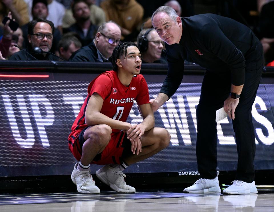 Rutgers Scarlet Knights guard Derek Simpson (0) shares a moment with Rutgers Scarlet Knights head coach Steve Pikiell during the second half against the Purdue Boilermakers at Mackey Arena.