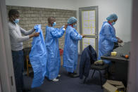 Medical workers who travelled on the COVID-19 vaccine train parked at the Swartkops railroad yard outside Gqeberha, South Africa, prepare to vaccinate factory workers as part of an outreach program Thursday Sept. 23, 2021. South Africa has sent a train carrying COVID-19 vaccines into one of its poorest provinces to get doses to areas where healthcare facilities are stretched. The vaccine train, named Transvaco, will go on a three-month tour through the Eastern Cape province and stop at seven stations for two weeks at a time to vaccinate people. (AP Photo/Jerome Delay)