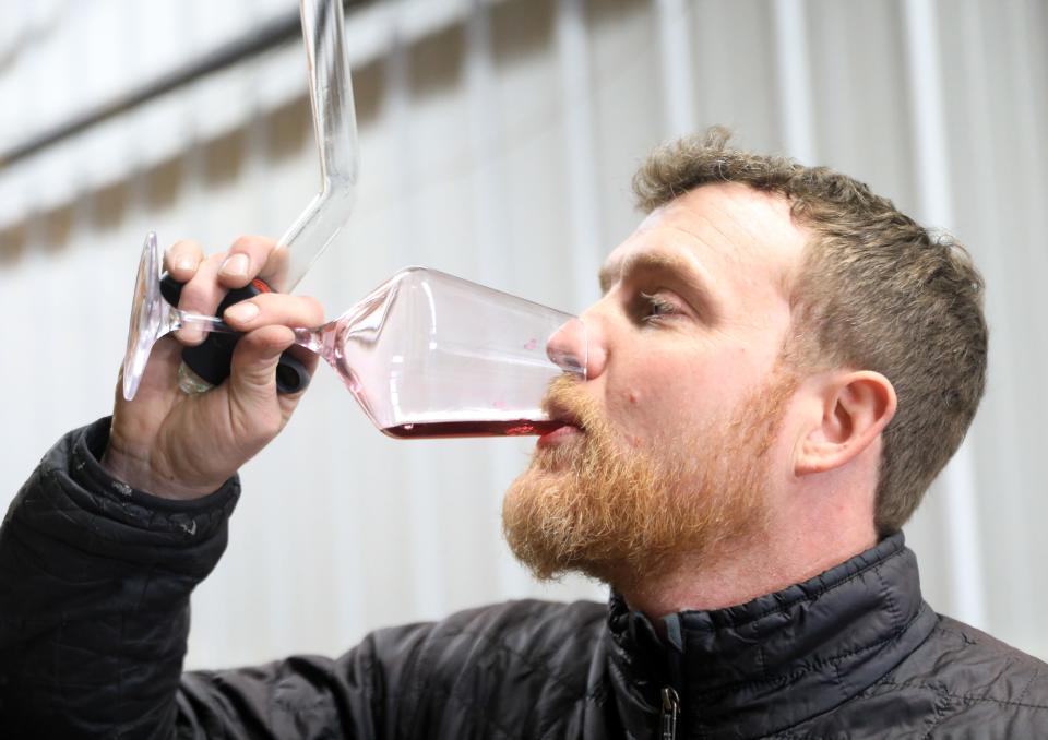 Ian Bearup, the winemaker at Millbrook Vineyards & Winery checks to see how the flavor in a wine is developing while in the barrel room at the winery on February 22, 2024.