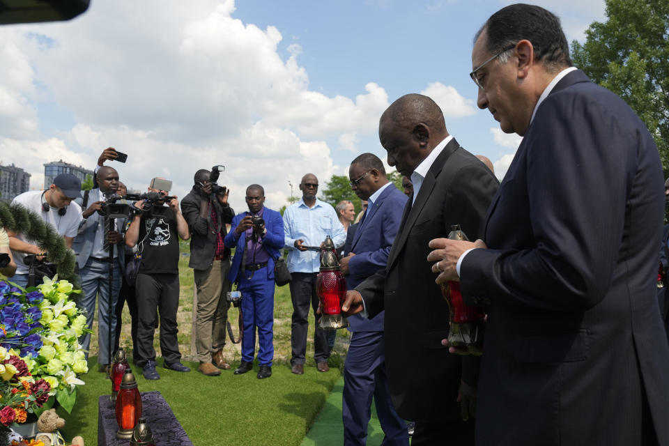 South African President Cyril Ramaphosa, second from right, Senegal's President Macky Sall, left, and Egypt's Prime Minister Mustafa Madbuly attend a commemoration ceremony at a site of a mass grave in Bucha, on the outskirts of Kyiv, Ukraine, Friday, June 16, 2023. South African President Cyril Ramaphosa arrived in Ukraine on Friday as part of a delegation of African leaders and senior officials seeking ways to end Kyiv's 15-month war with Russia. (AP Photo/Efrem Lukatsky)