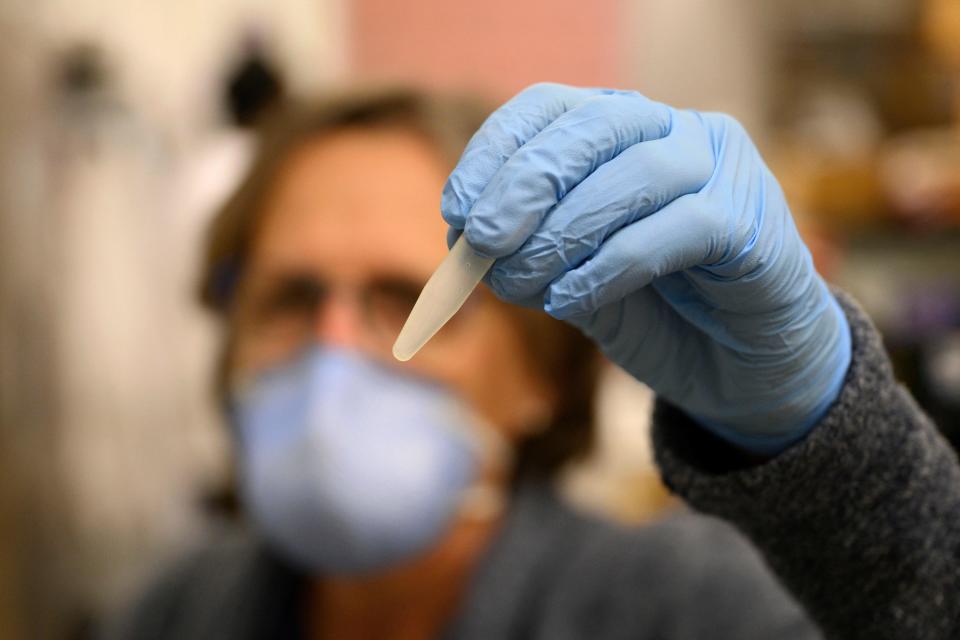 Professor Monica Trujillo holds up a wastewater sample at a lab at Queens College on August 25, 2022, in New York City. Since the first polio case was identified in July in New York's Rockland County, the virus has been detected in New York City sewage, suggesting wider spread. / Credit: ANGELA WEISS/AFP via Getty Images