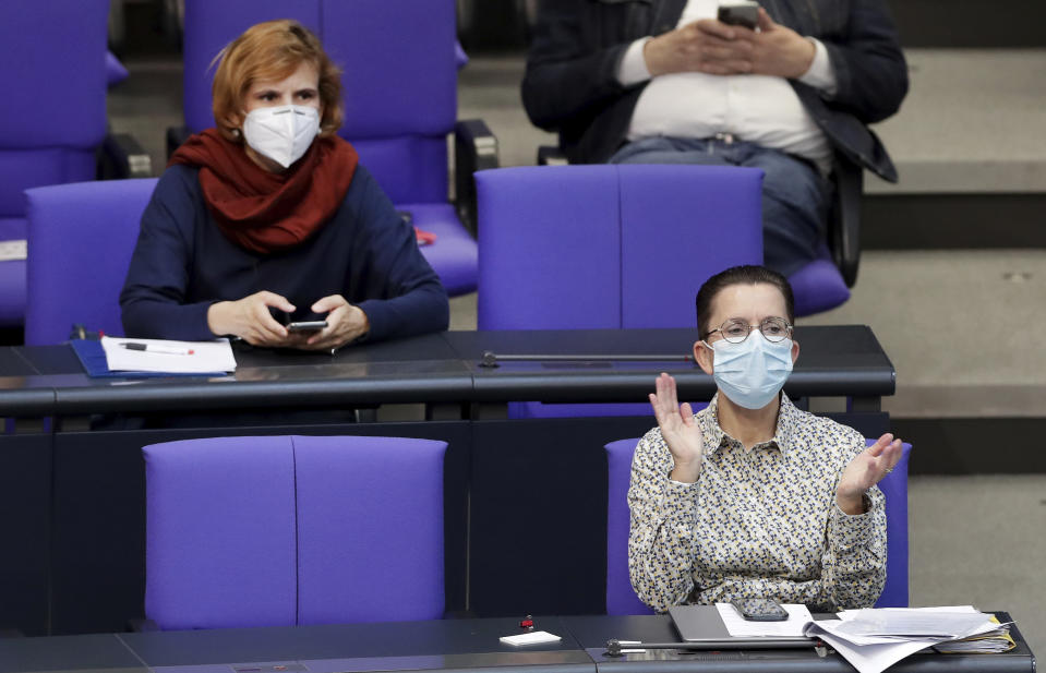 Katja Kipping, left , co-chairwoman of the German Left Party, and Petra Sitte, right, deputy faction leader of the Left Party, wear face masks as they attend a meeting of the German federal parliament, Bundestag, at the Reichstag building in Berlin, Germany, Thursday, April 23, 2020. (AP Photo/Michael Sohn)