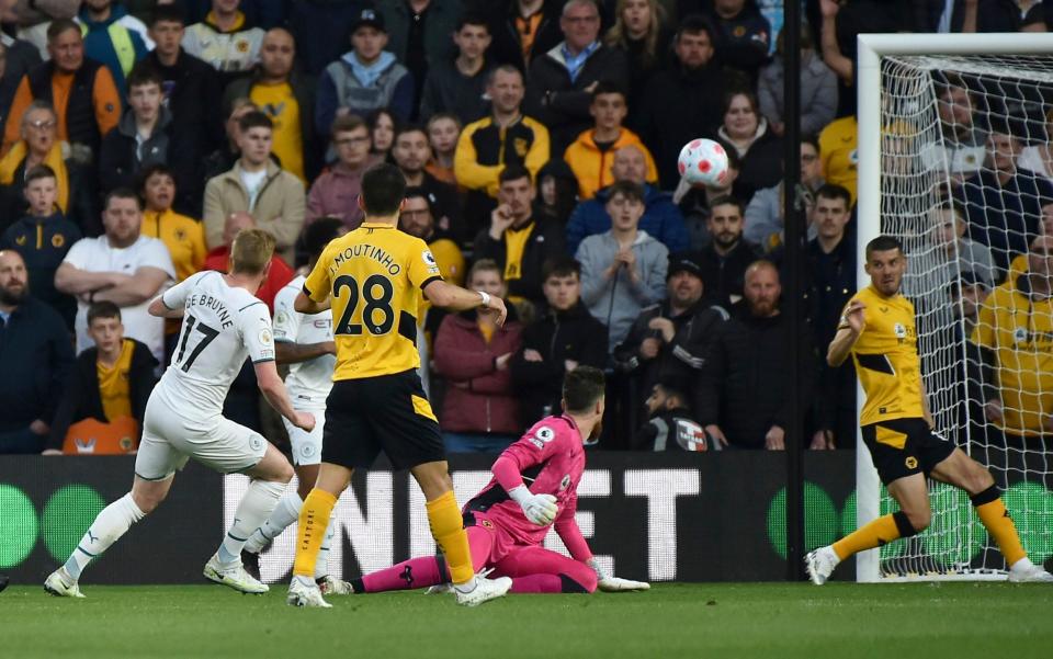 Kevin De Bruyne lifts the ball past Jose Sa to score his second goal at Wolves - AP