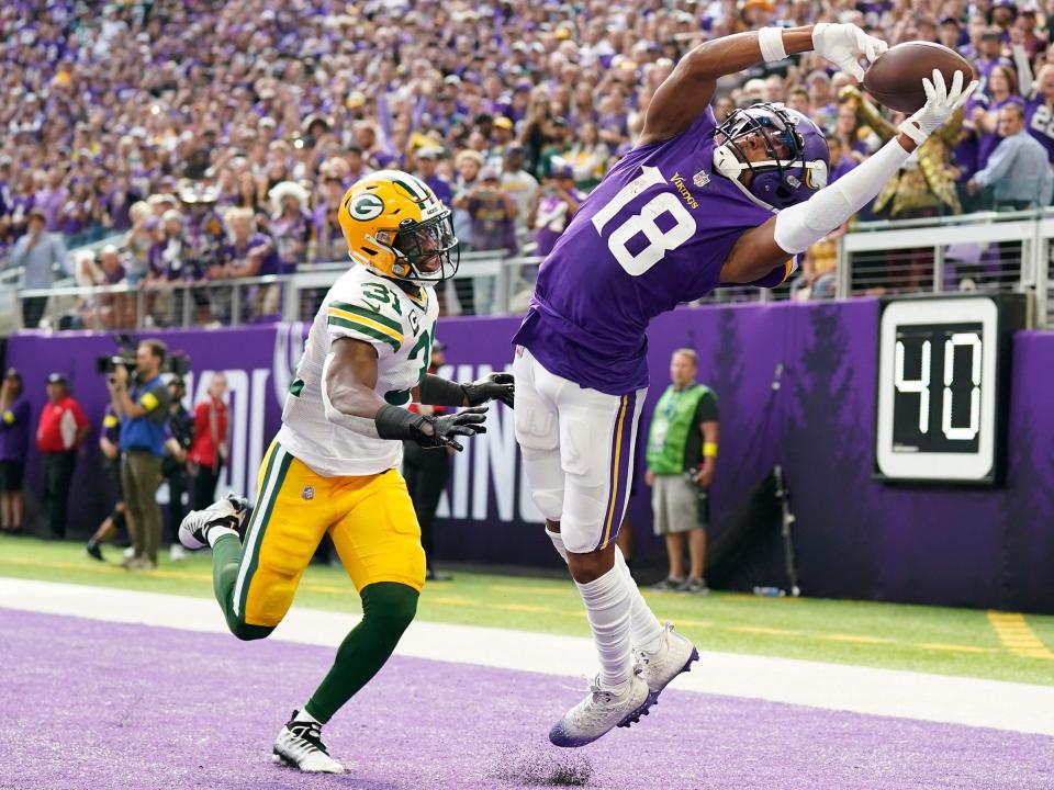 Justin Jefferson attempts to secure a catch against the Green Bay Packers.