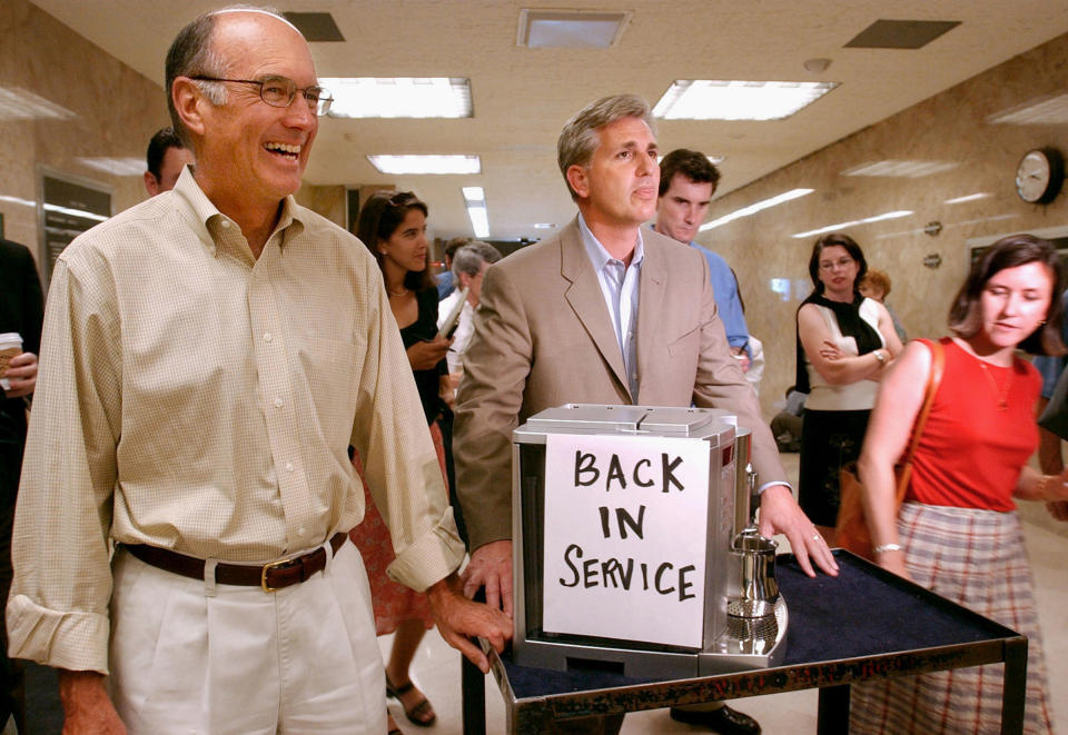 In this July 20, 2004 photo, then-California Assembly Republican Leader Kevin McCarthy, center, and Senate Republican Leader Dick Ackerman, left, wheel a cappuccino machine into the Governor's office at the Capitol in Sacramento. McCarthy, the majority leader who’s favored to become the next speaker of the House, has energetically nurtured GOP legislators in the House since he was elected to Congress nine years ago.<span class="copyright">Steve Yeater—AP</span>