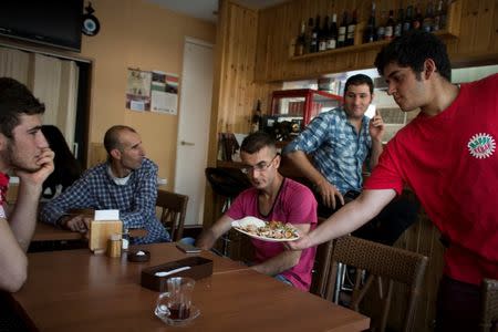 Kurdish men gather a local Kurdish run kebab house that doubles as their main social meeting place in Warabi, north of Tokyo, October 4, 2015. REUTERS/Thomas Peter