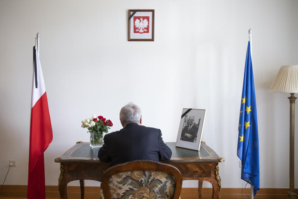 Istvan Nagy, Ambassador of Hungary to Switzerland, signs the condolence book for Pawel Adamowicz, Mayor of Gdansk, at the residence of Poland's Ambassador in Switzerland in Bern, Switzerland, Friday, Jan. 18, 2019. The Polish embassy opened a condolonce book after the tragic death of Pawel Adamowicz, Mayor of Gdansk. (Peter Klaunzer/Keystone via AP)