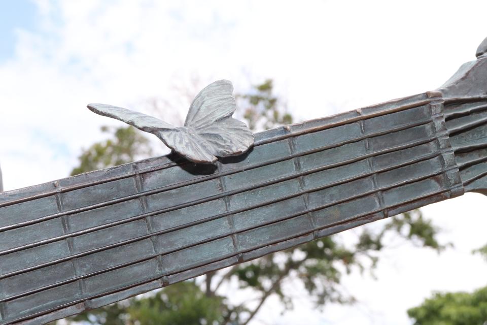 A butterfly on a guitar neck, which is part of a statue of Dolly Parton in Sevierville, Tennessee