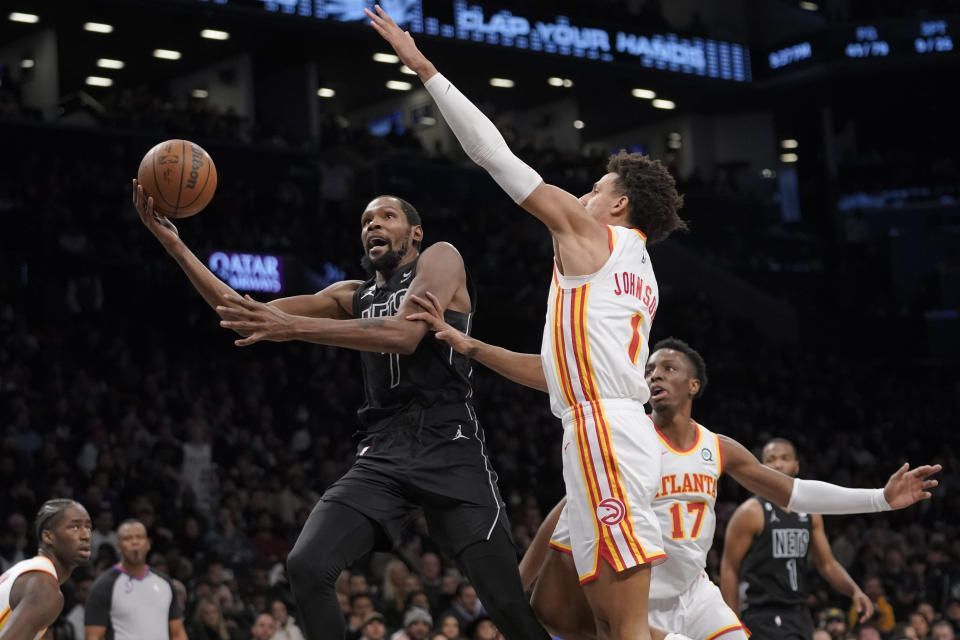 Brooklyn Nets forward Kevin Durant (7) goes to the basket against Atlanta Hawks forward Jalen Johnson (1) during the second half of an NBA basketball game Friday, Dec. 9, 2022, in New York. The Nets won 120-116. (AP Photo/Mary Altaffer)