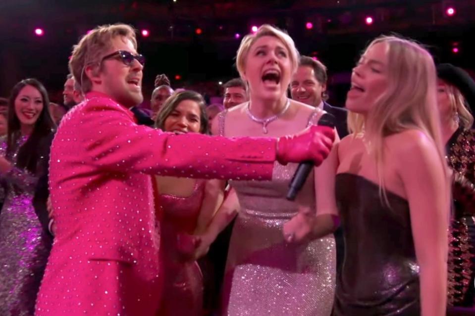 Margot Robbie sings along during the performance at the 96th Academy Awards. ABC