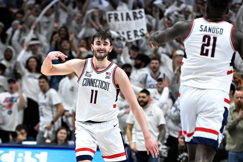 UConn's Alex Karaban (11) gestures after making a basket against Providence during the second half of an NCAA college basketball game Wednesday, Feb. 22, 2023, in Storrs, Conn. (AP Photo/Jessica Hill)