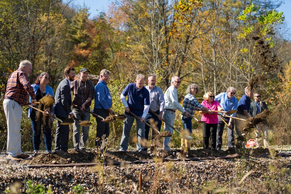 Henderson County commissioners and local partners participate in the Oct. 28 groundbreaking of the first six-mile stretch of the Ecusta Trail at the Veterans Healing Farm in Hendersonville.