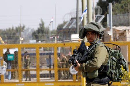 FILE PHOTO: An Israeli soldier stands near the Quneitra crossing in the Golan Heights on the border line between Israel and Syria, October 15, 2018. REUTERS/Amir Cohen/File Photo