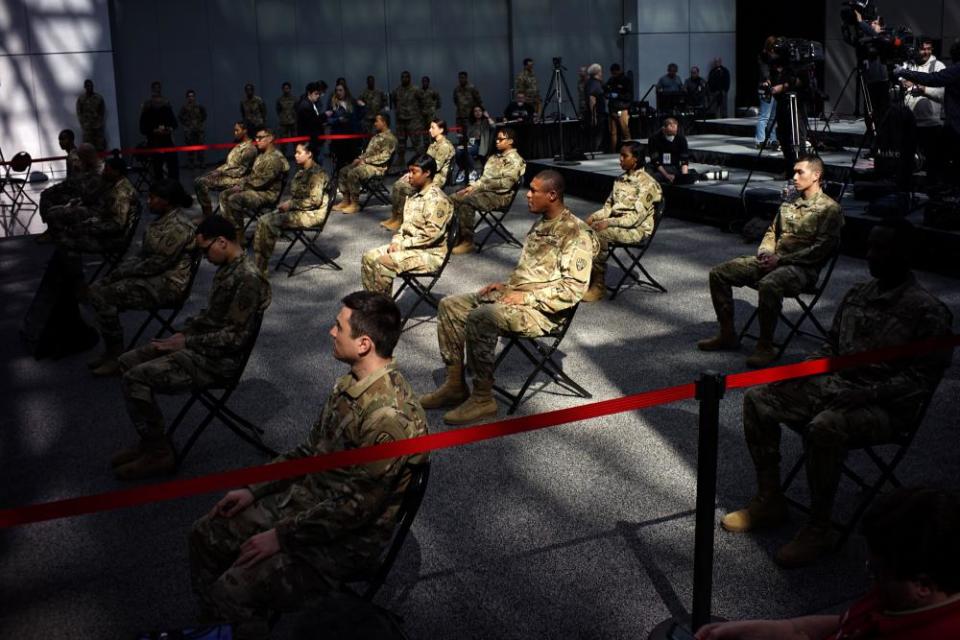 Members of the National Guard wait the arrival of New York Gov Andrew Cuomo at the Javits Convention Center, which is being turned into a hospital to help fight coronavirus cases on March 27, 2020 in New York City. Across the country, schools, businesses, and places of work have either been shutdown or are restricting hours of operation as health officials try to slow the spread of COVID-19.