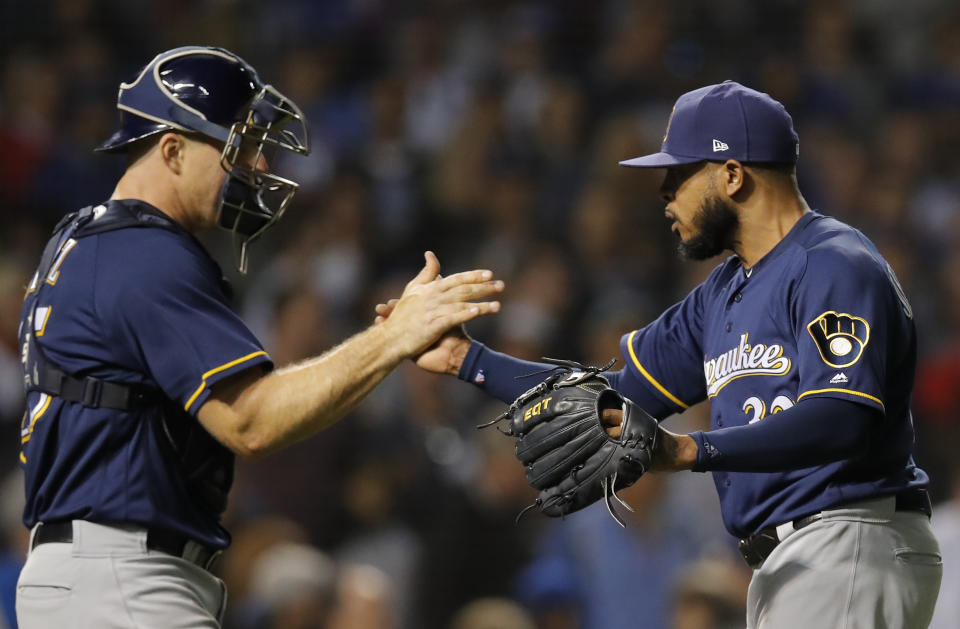 Milwaukee Brewers' Jeremy Jeffress, right and Milwaukee Brewers' Erik Kratz celebrate their team's win over the Chicago Cubs during their baseball game Monday, Sept. 10, 2018, in Chicago. (AP Photo/Jim Young)