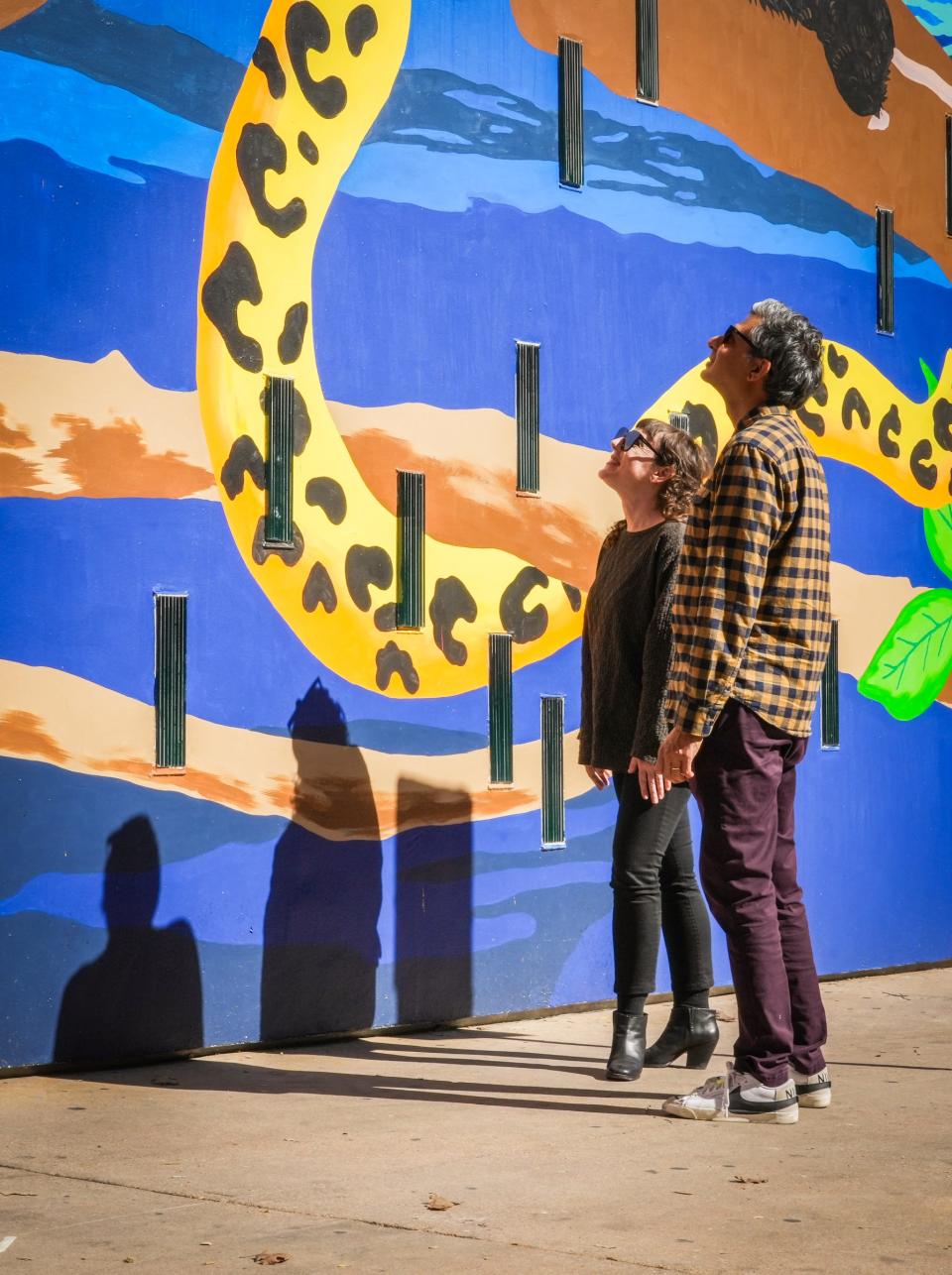 Artist Manik Raj Nakra, right, and The Contemporary Austin head curator and director of curatorial affairs Alex Klein, left, look at Nakra's new mural on the side of Jones Center in downtown Austin.