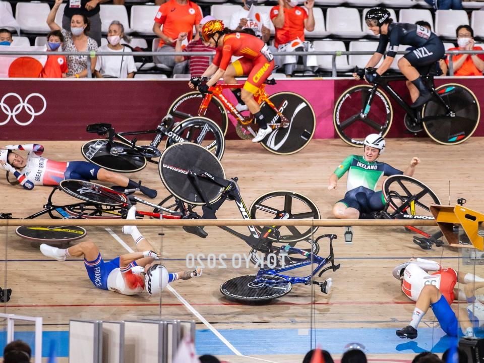 Riders are strewn on the track cycling course after a crash at the Tokyo Olympics.