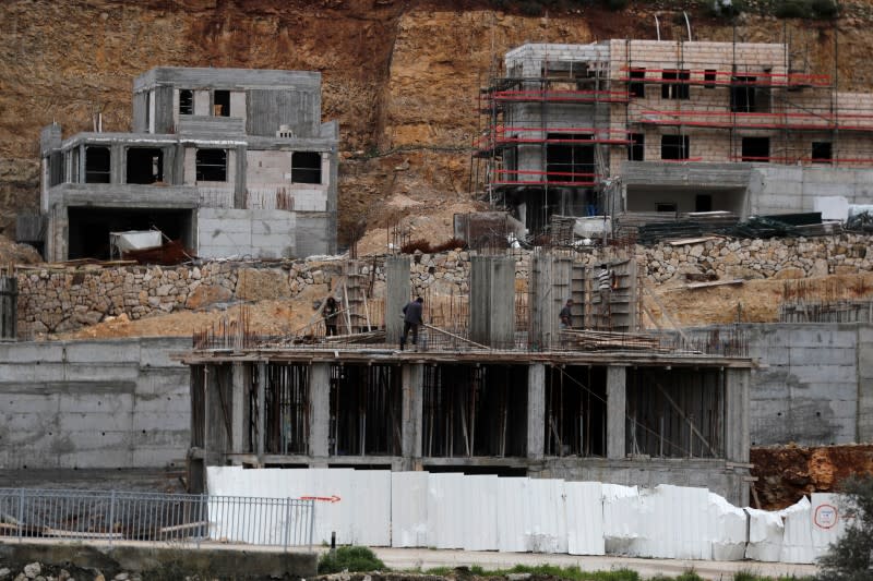 Palestinian Labourers work at a construction site in the Israeli settlement of Ramat Givat Zeev in the Israeli-occupied West Bank