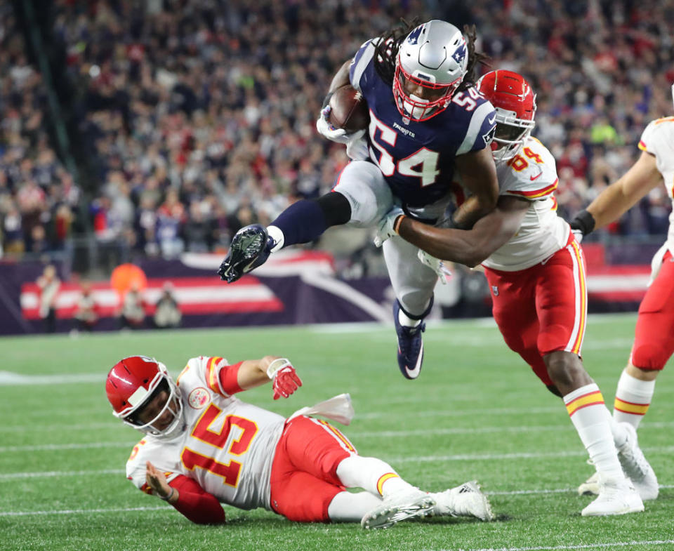 Dont’a Hightower of New England runs back an interception of Patrick Mahomes (15) in Sunday night’s game. (Getty)