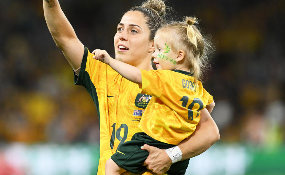 Katrina Gorry with daughter Harper after the Matildas' win over France at the Women's World Cup. 