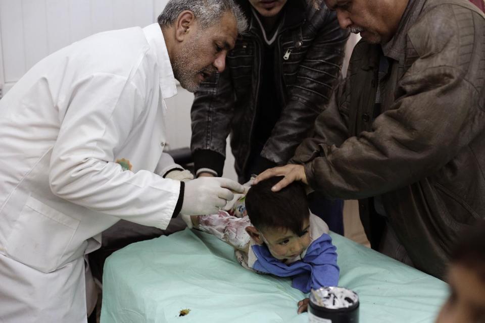 A child with severe burns from scalding water is treated at a hospital in the Zahra neighborhood of Mosul, Iraq, Tuesday, Feb. 14, 2017. Doctors in the small clinic in eastern Mosul say that since the operation to retake the city began months ago, they've only received intermittent deliveries of supplies. (AP Photo/Bram Janssen)