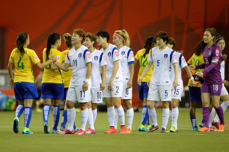 Jun 9, 2015; Montreal, Quebec, CAN; Players from Brazil and Korea Republic shake hands following their Group E soccer match in the 2015 FIFA women's World Cup at Olympic Stadium. Brazil defeated Korea Republic 2-0. Mandatory Credit: Eric Bolte-USA TODAY Sports