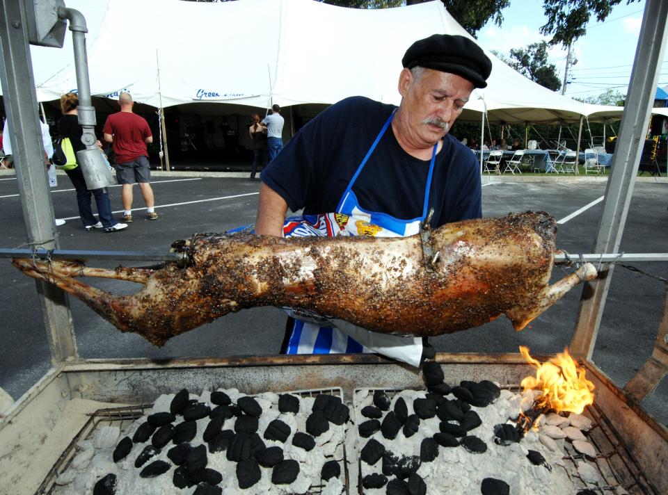 Dimitrios Soulantikas adds charcoal as he roasts a lamb at the 2009 Augusta Greek Festival. Soulantikos said he bastes the meat with olive oil, oregano and fresh lemon juice for five to six hours.