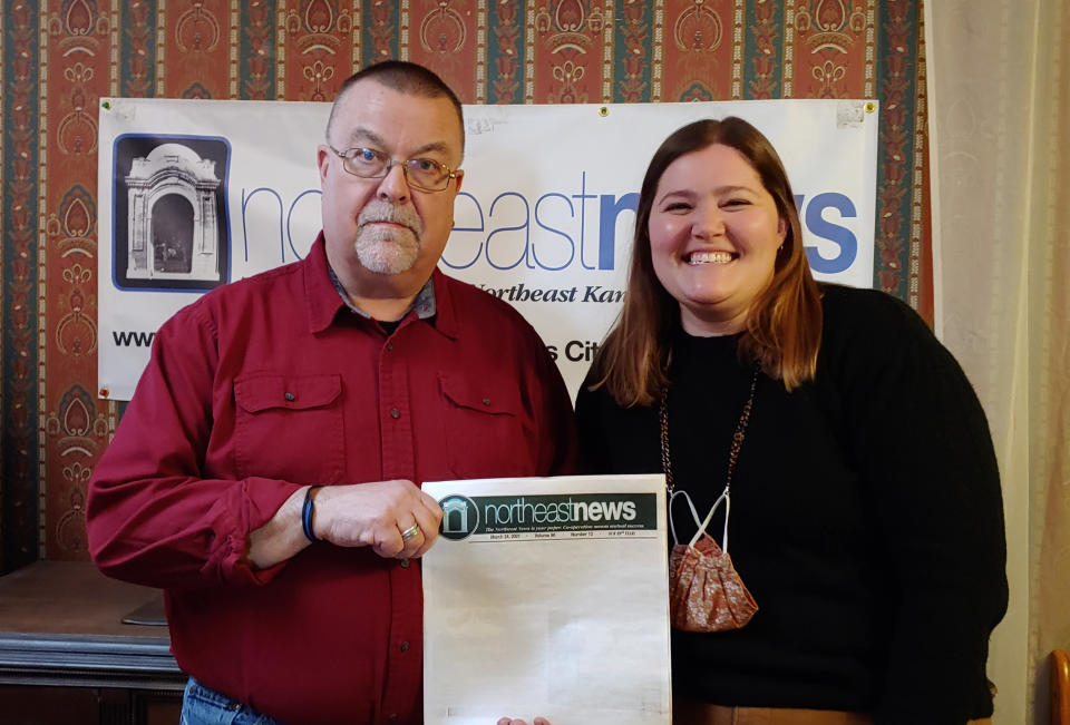 Publisher Michael Bushnell, left, and Managing Editor Abby Hoover pose in the offices of The Northeast News, a community paper in Kansas City, Mo., on March 31, 2021. The paper chose to leave the front page of their March 24 issue blank to show community members what they'd miss if the newspaper folded. (The Northeast News via AP)