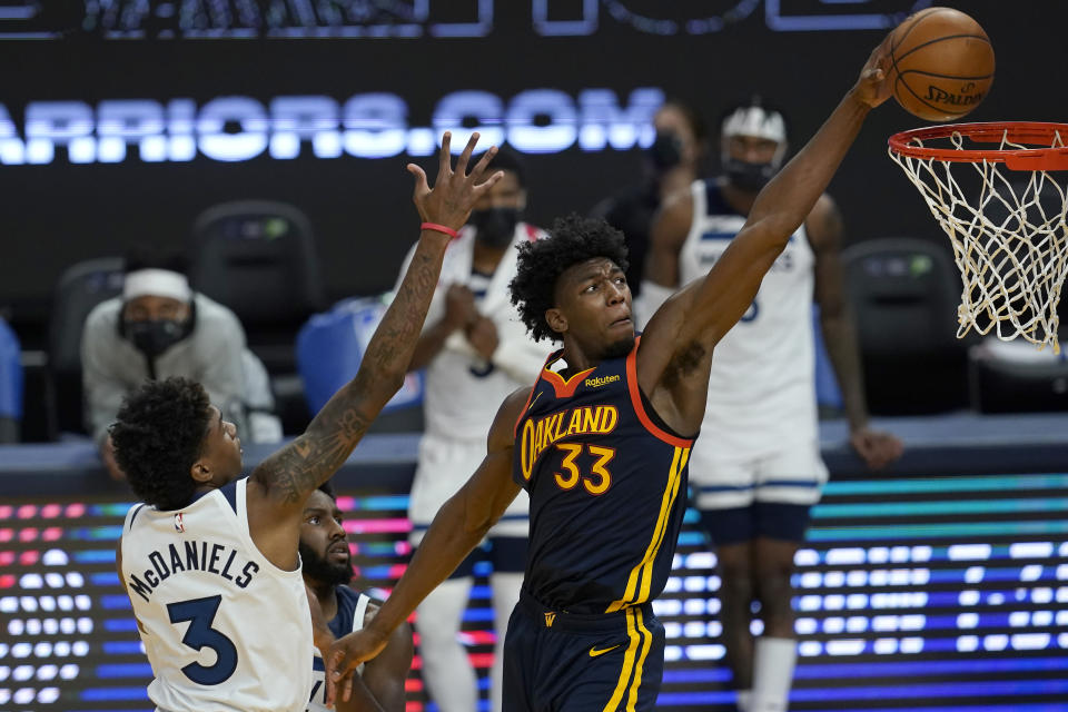 Golden State Warriors center James Wiseman (33) dunks against Minnesota Timberwolves forward Jaden McDaniels (3) during the second half of an NBA basketball game in San Francisco, Wednesday, Jan. 27, 2021. (AP Photo/Jeff Chiu)