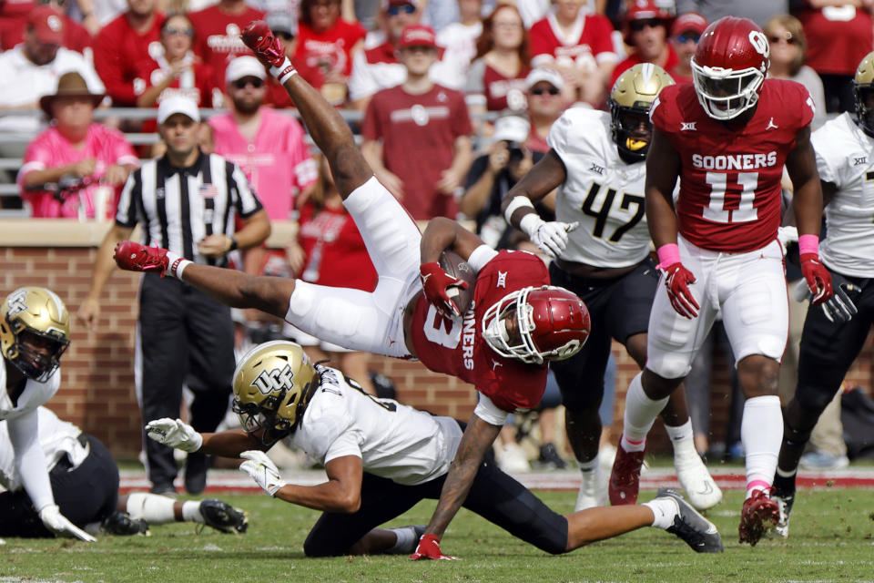 Oklahoma wide receiver Jalil Farooq (3) is tripped up by Central Florida defensive back Demari Henderson on a kickoff return in the first half of an NCAA college football game, Saturday, Oct. 21, 2023, in Norman, Okla. (AP Photo/Nate Billings)