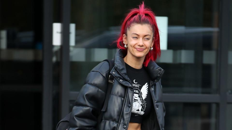 Dianne walking in cargos and cropped tee