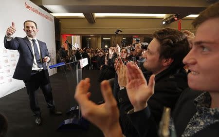 Former French education minister Benoit Hamon (L) reacts after partial results in the second round of the French left's presidential primary election in Paris, France, January 29, 2017. REUTERS/Christian Hartmann