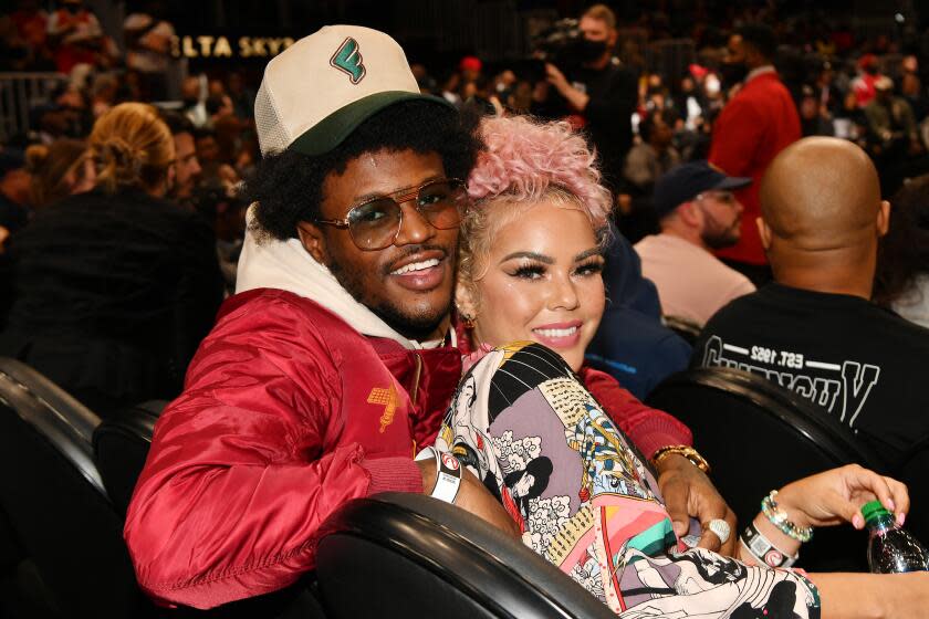 ATLANTA, GEORGIA - DECEMBER 17: DC Young Fly and Jacky Oh attend the game between the Denver Nuggets and the Atlanta Hawks at State Farm Arena on December 17, 2021 in Atlanta, Georgia. (Photo by Paras Griffin/Getty Images)